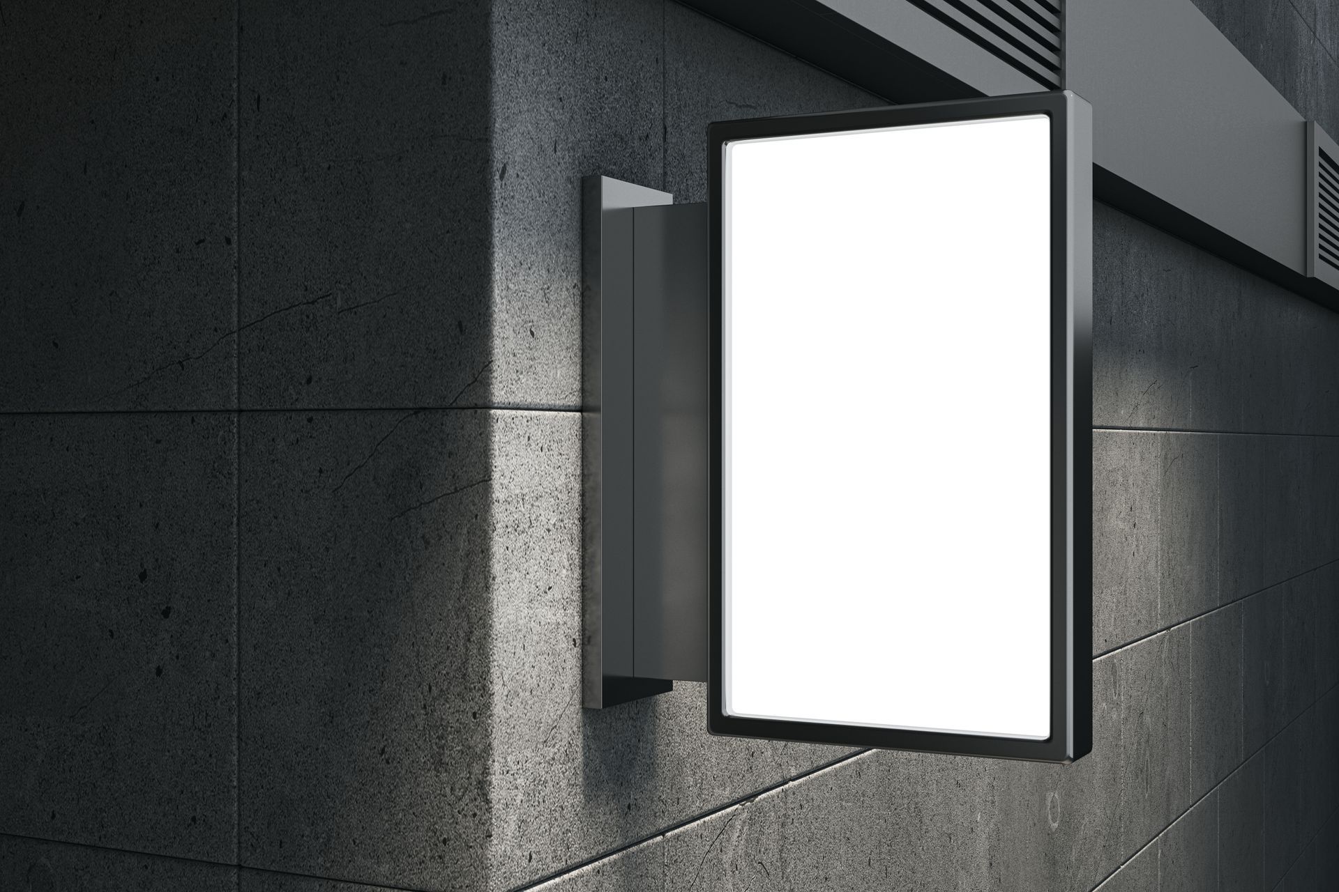 An illuminated wall-mounted sign glowing on a dark exterior surface.