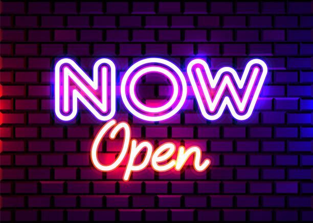 Neon sign that reads “Now open” in front of brick wall, representing sign light retrofittings.