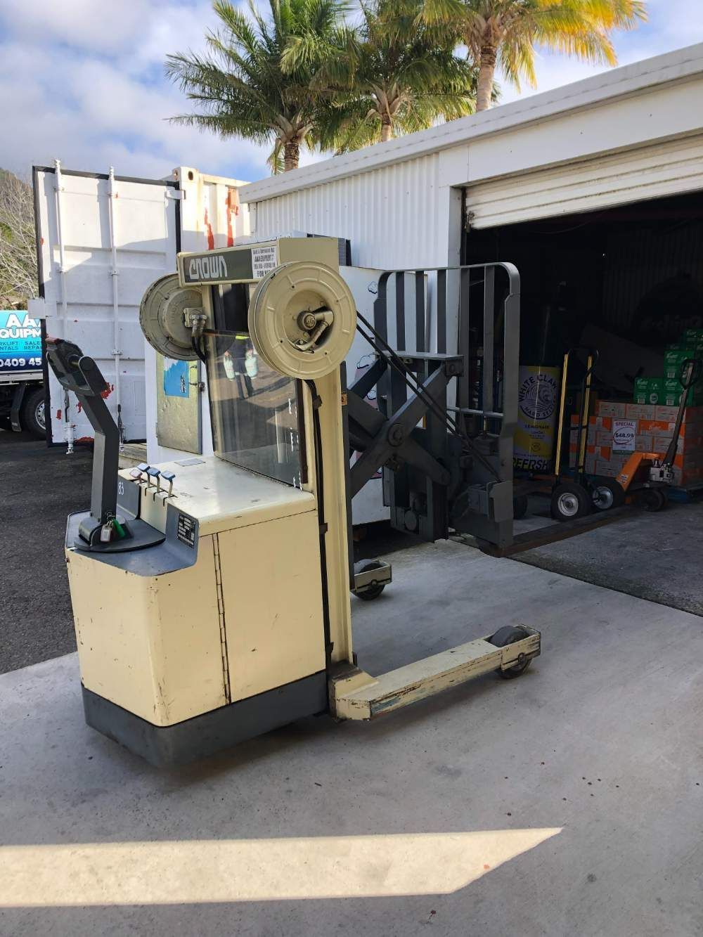 A Forklift Is Parked in Front of A Garage — AAA Equipment Pty Ltd In Taree, NSW