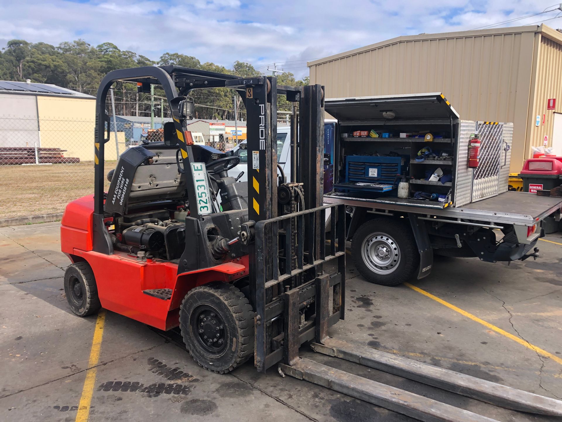 A red forklift with a repair truck parked next to it — AAA Equipment Pty Ltd In Redbank, NSW