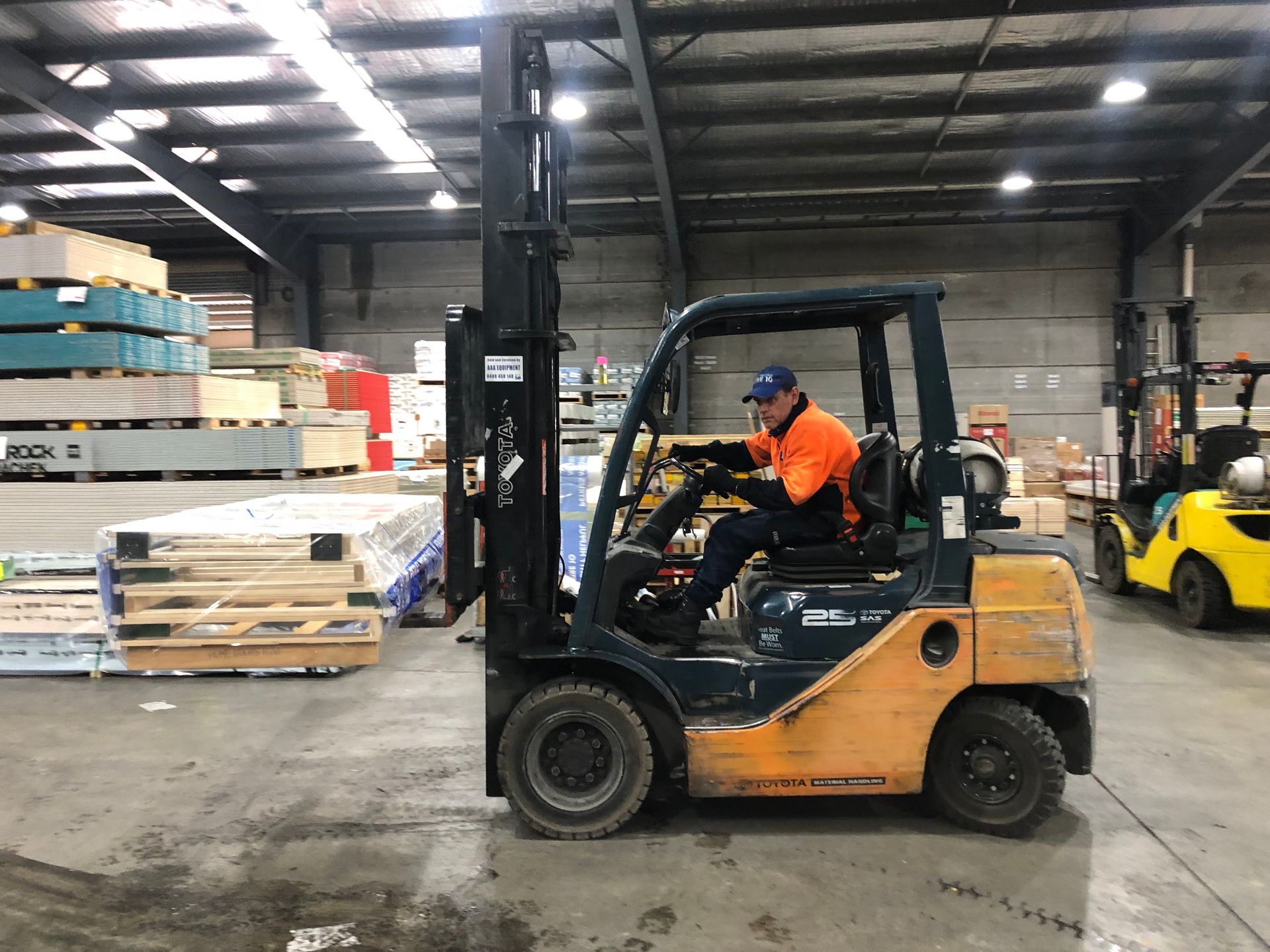A Forklift Is Moving Boxes in A Warehouse — AAA Equipment Pty Ltd In Redbank, NSW