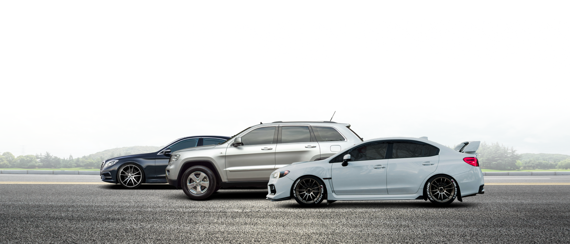 Three cars parked on a paved surface against a foggy backdrop | City Side Auto