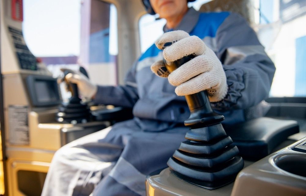 Woman is Sitting in the Driver 's Seat of a Construction Vehicle — Newcastle Cranes In Central Coast, NSW