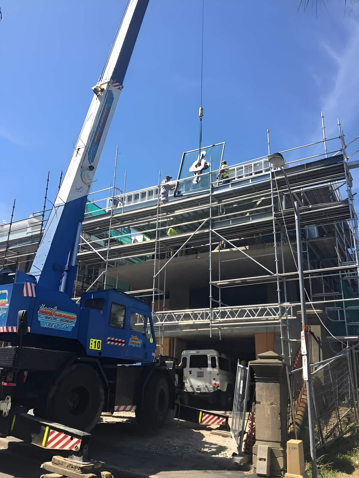 A Crane Is Being Used To Lift A Piece Of Metal On Top Of A Building — Newcastle Cranes In Port Stephens, NSW