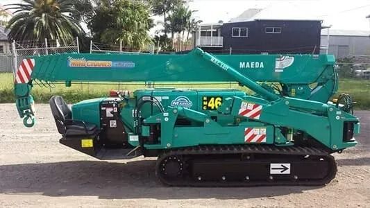 A Yellow and Gray Crane is Parked in a Parking Lot — Newcastle Cranes In Cardiff, NSW