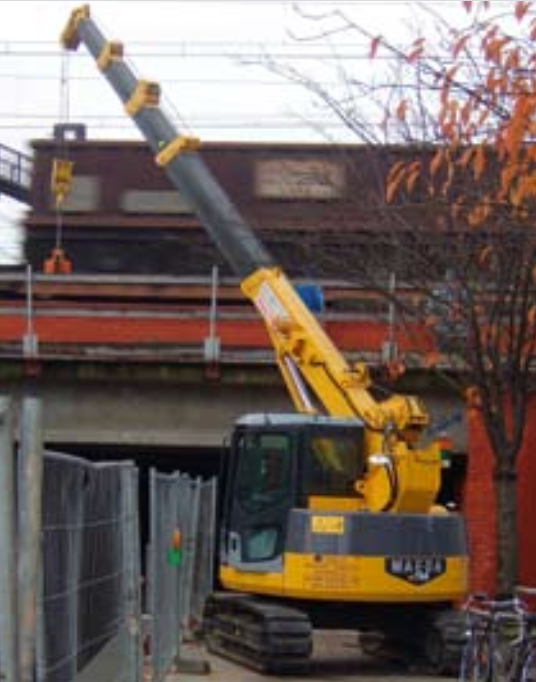 A Blue Crane is Parked Next to a White Crane in a Parking Lot — Newcastle Cranes In Cardiff, NSW
