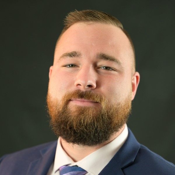 A man with a beard wearing a suit and tie