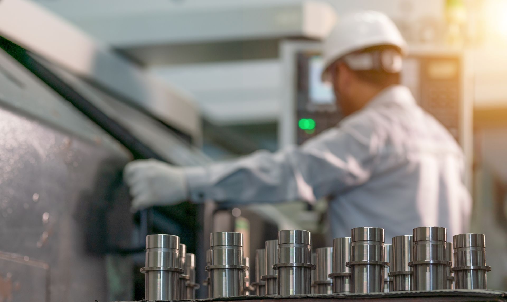 A man is working on a machine in a factory.