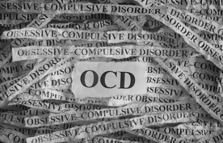 A pile of paper with the word ocd written on it.