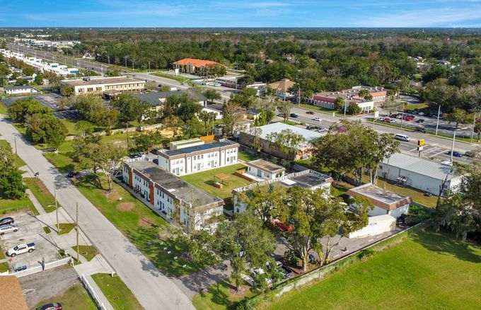 An aerial view of a residential area with lots of buildings and trees.