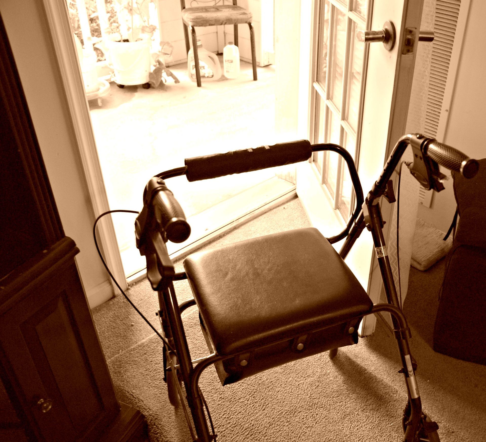 A walker sits in front of a door in a room