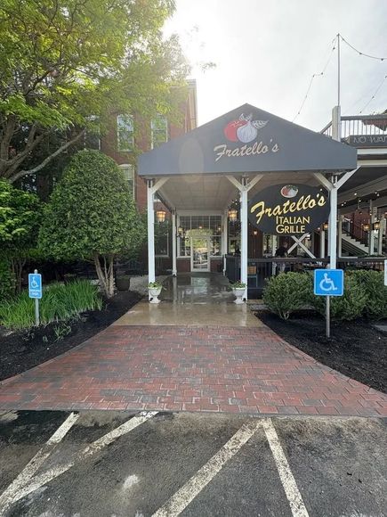 Exterior of Fratello's Italian Grill, with brick walkway and accessible parking signs.