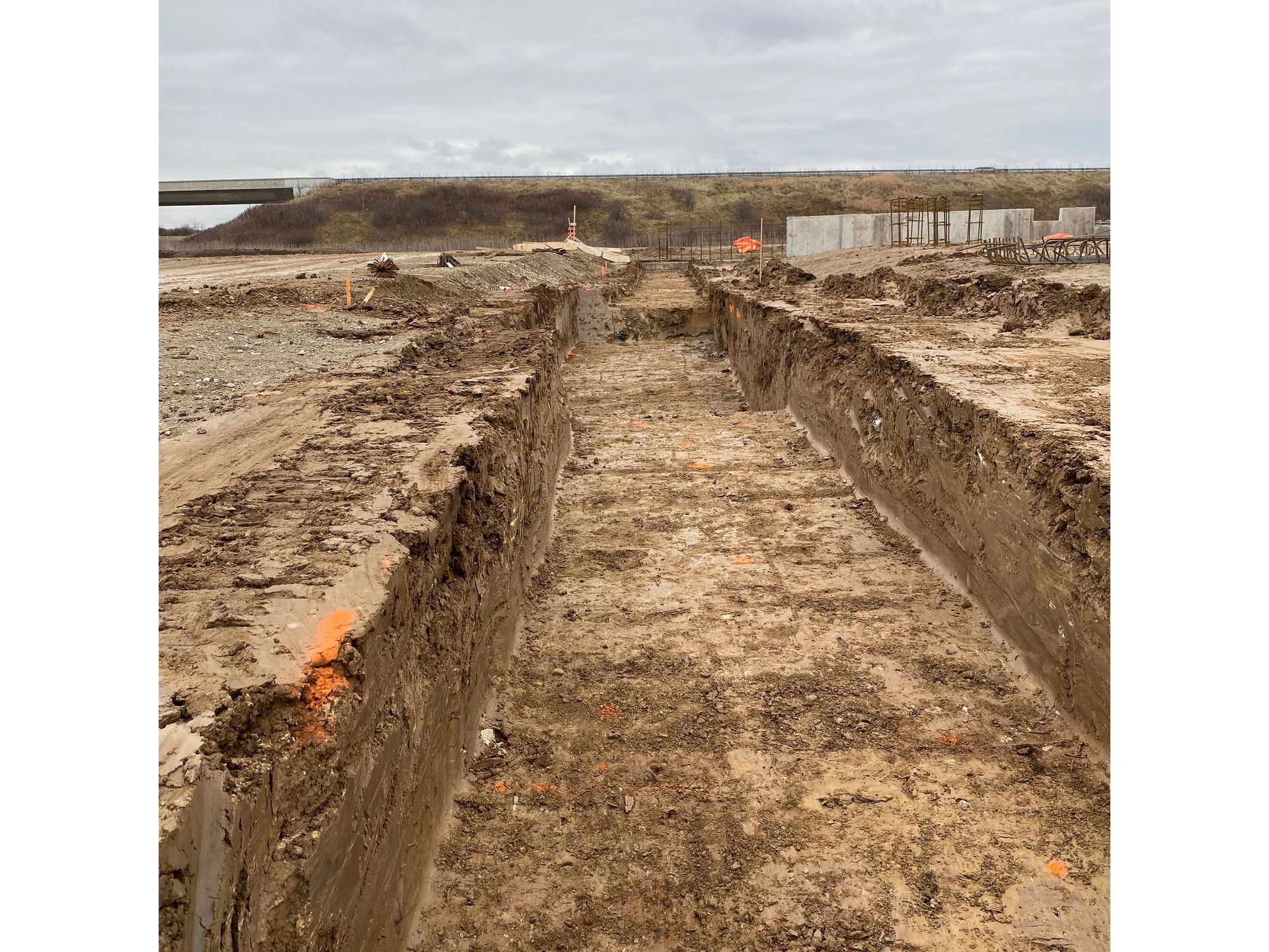 A dirt road is being built in the middle of a field.