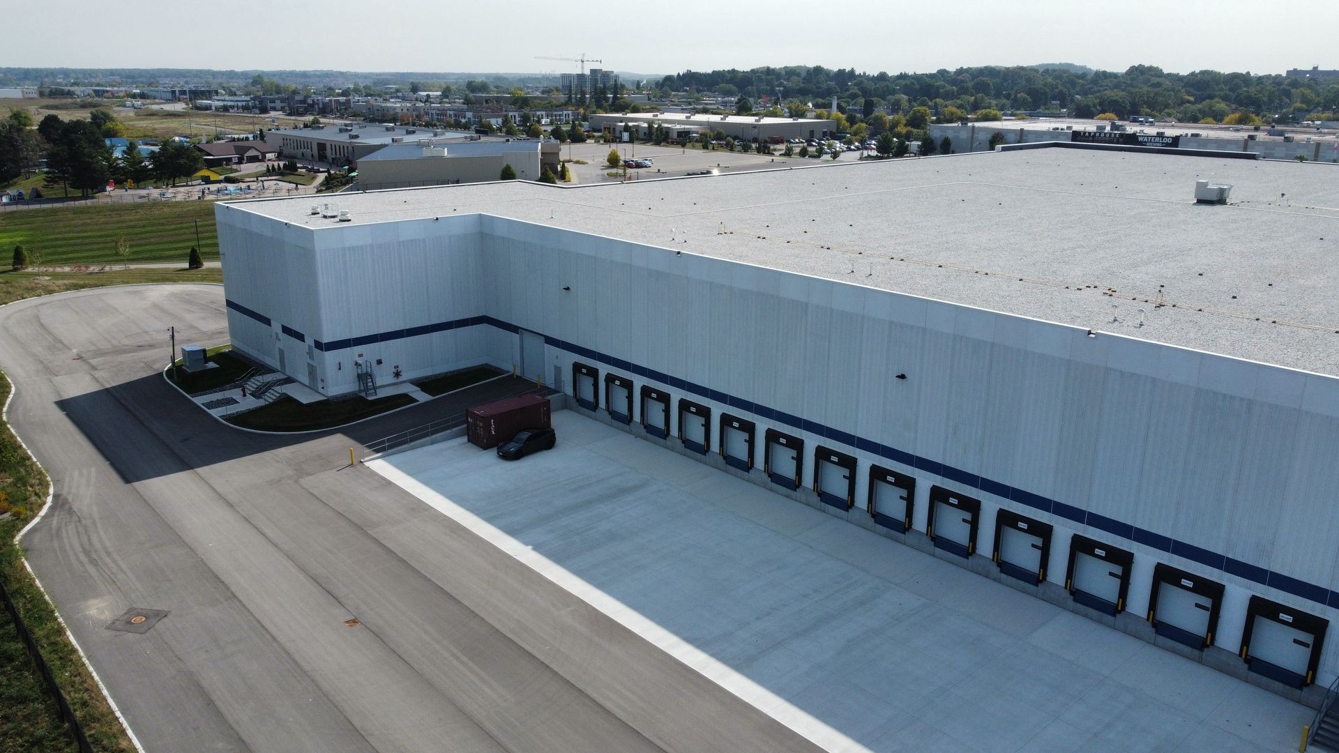 An aerial view of a large warehouse with a lot of doors
