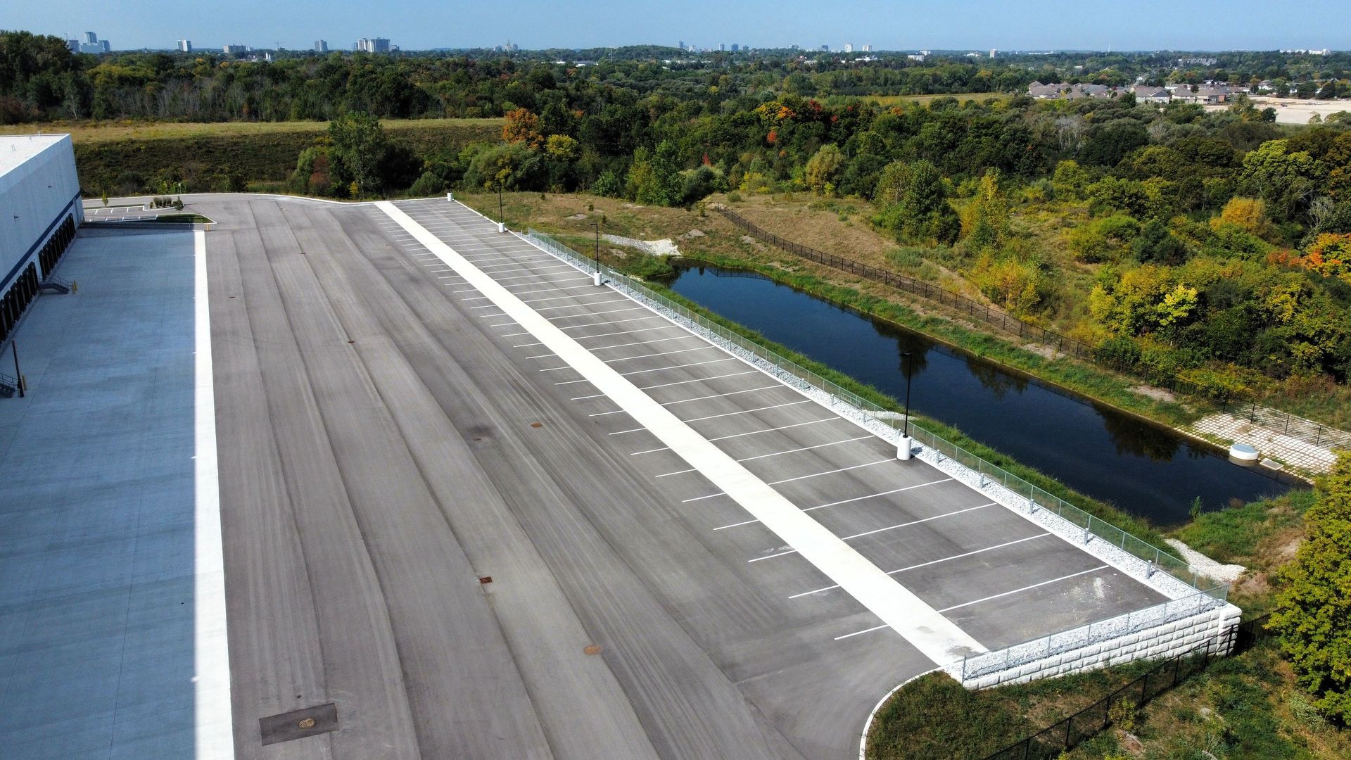 An aerial view of a large parking lot next to a body of water.