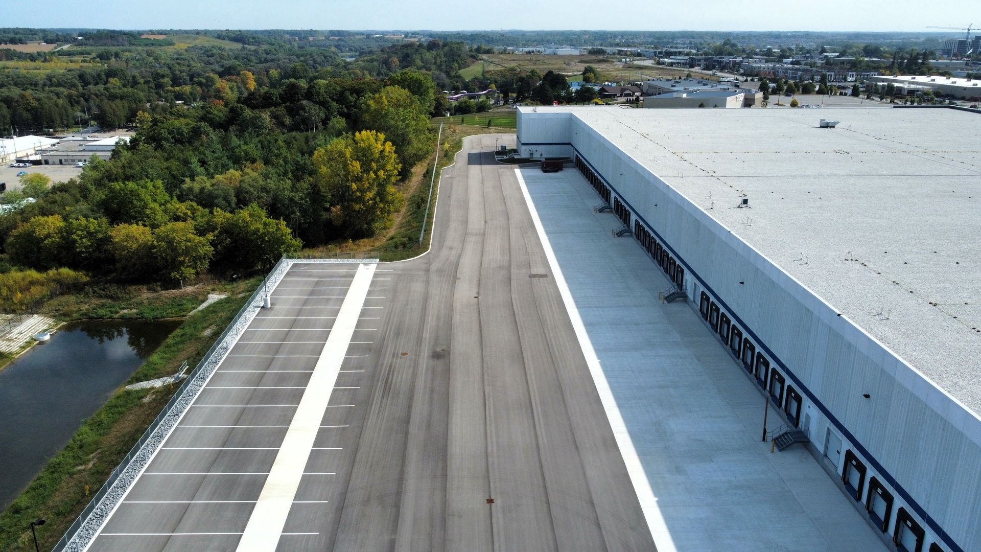 An aerial view of a parking lot next to a building