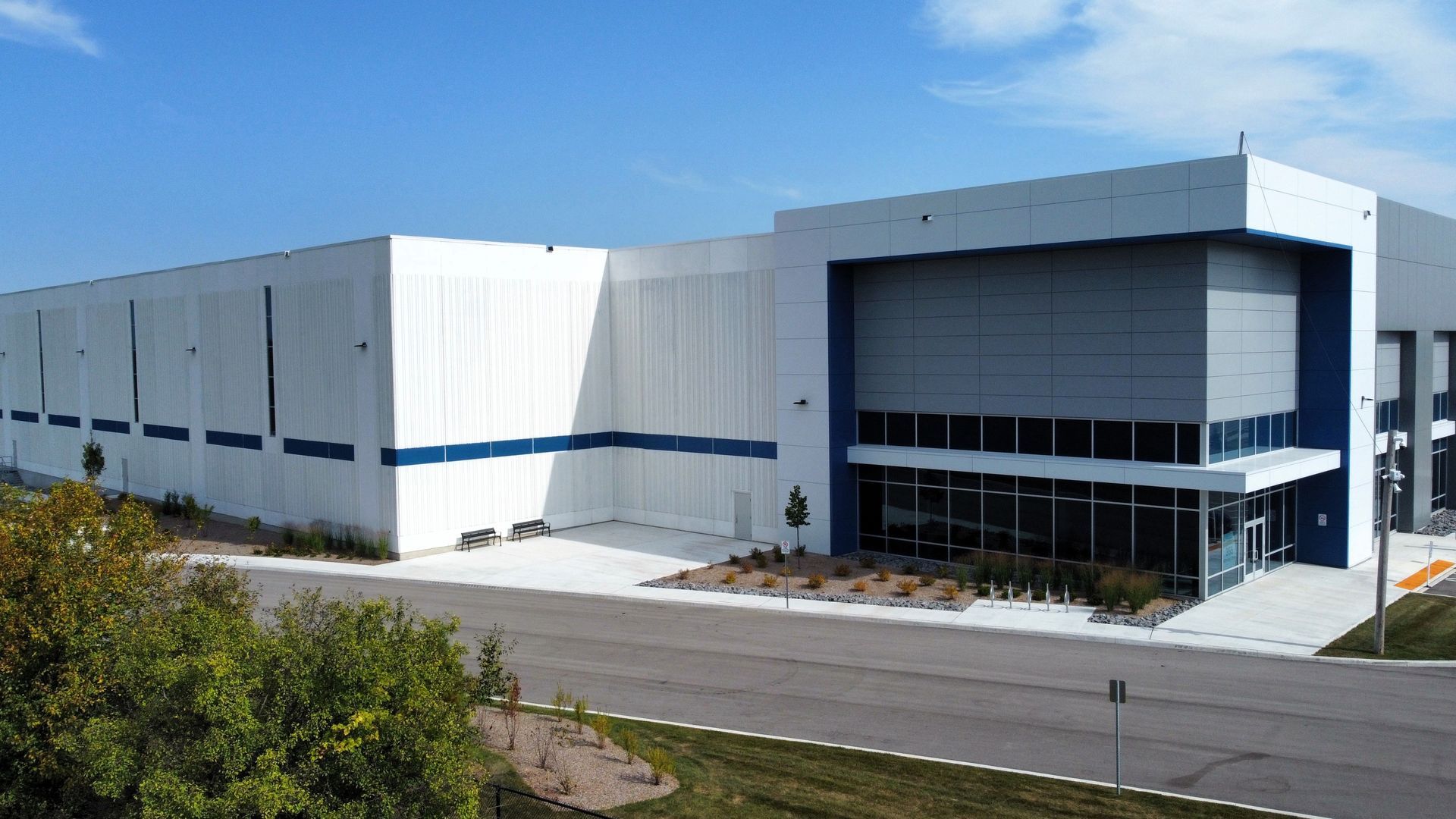 A large white and blue building with a lot of windows