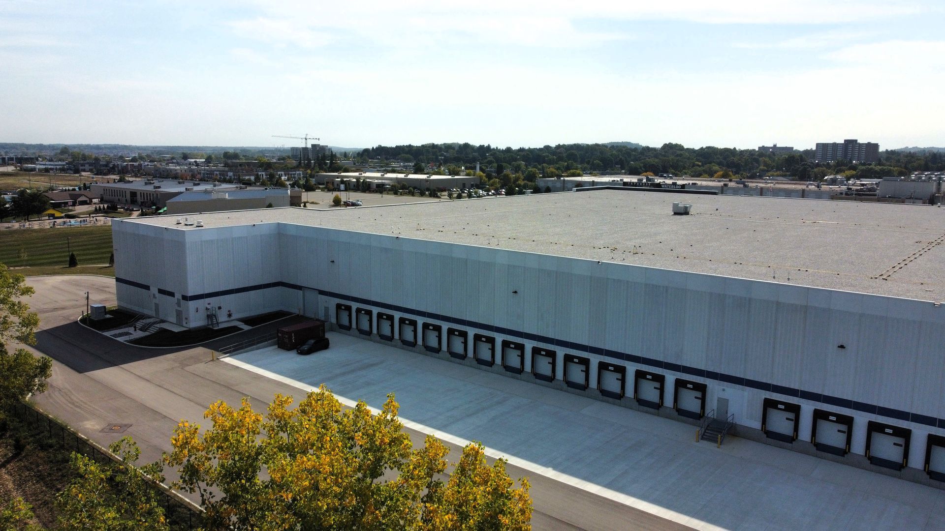 An aerial view of a large white building with a lot of loading docks.