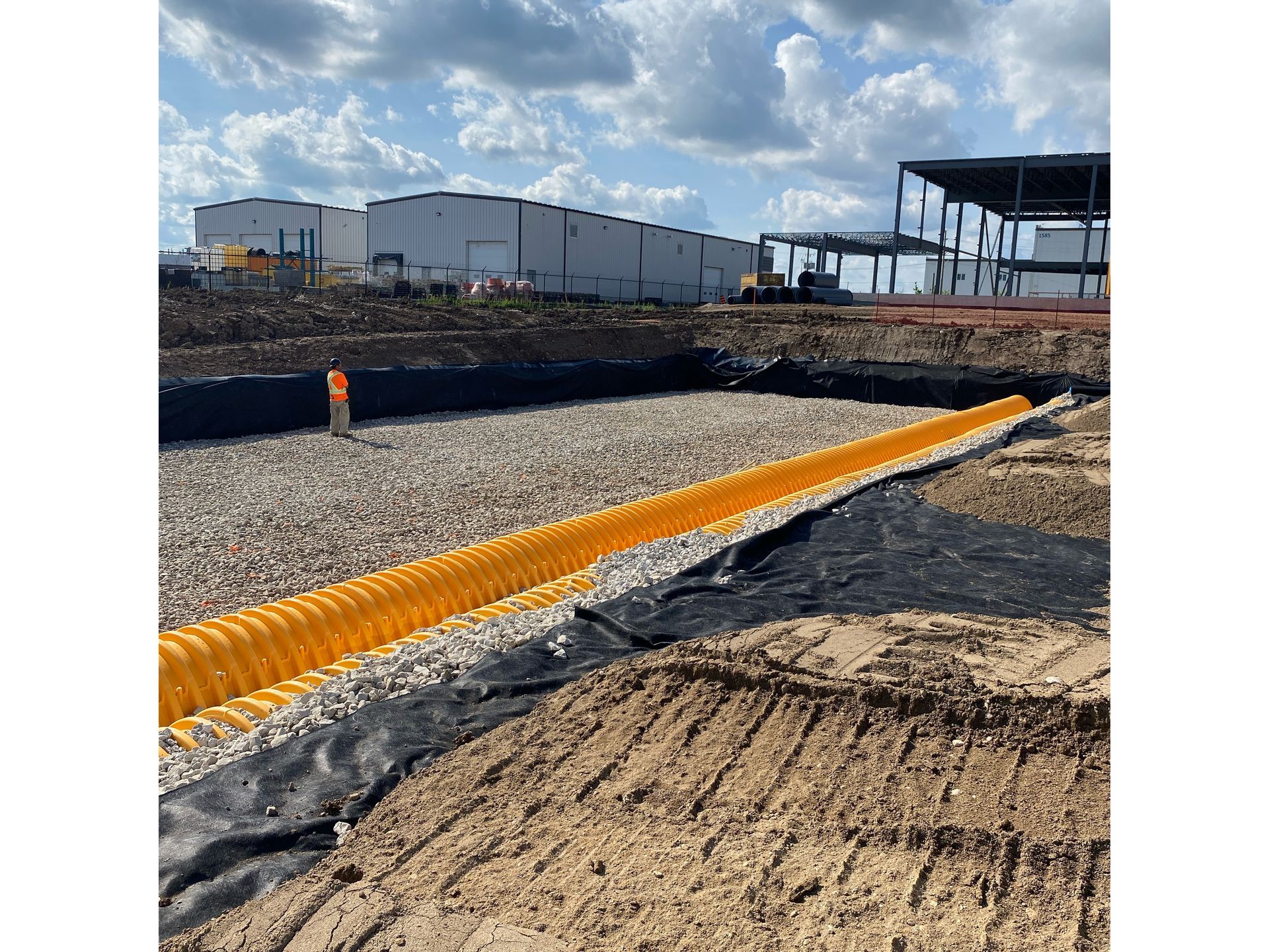 A large construction site with a large building in the background.