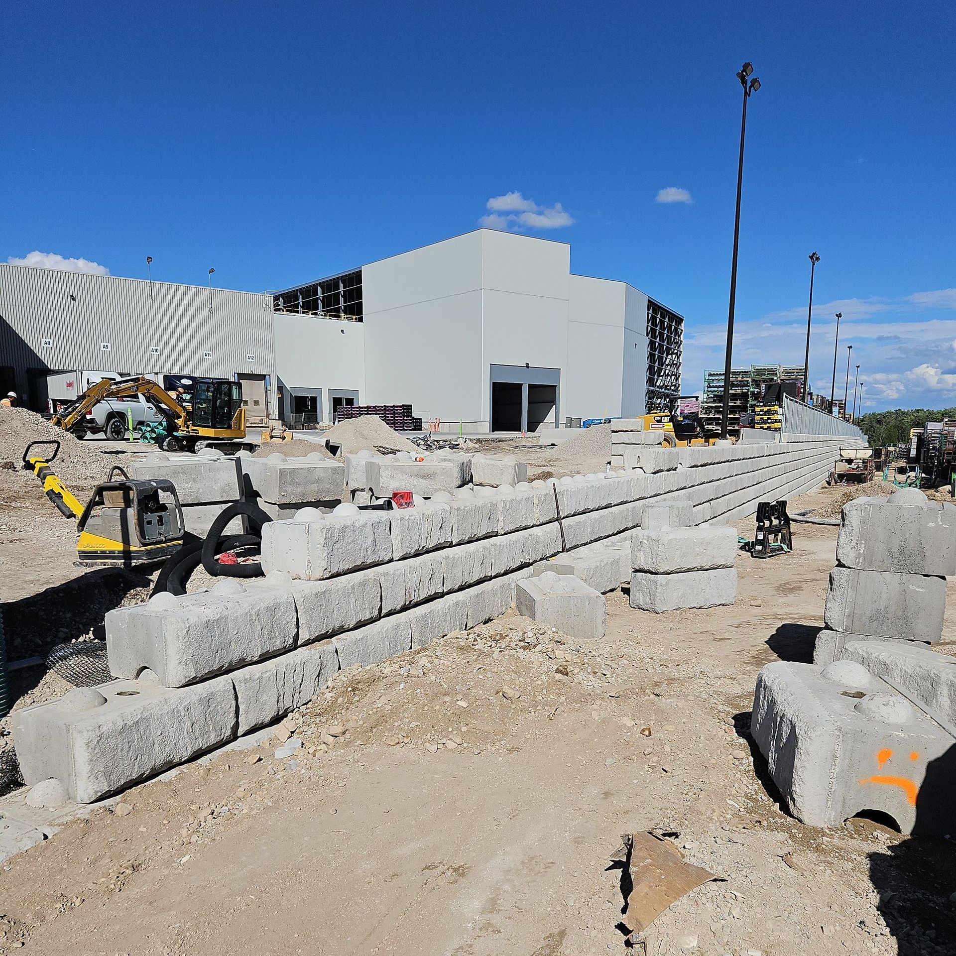 A construction site with a large white building in the background