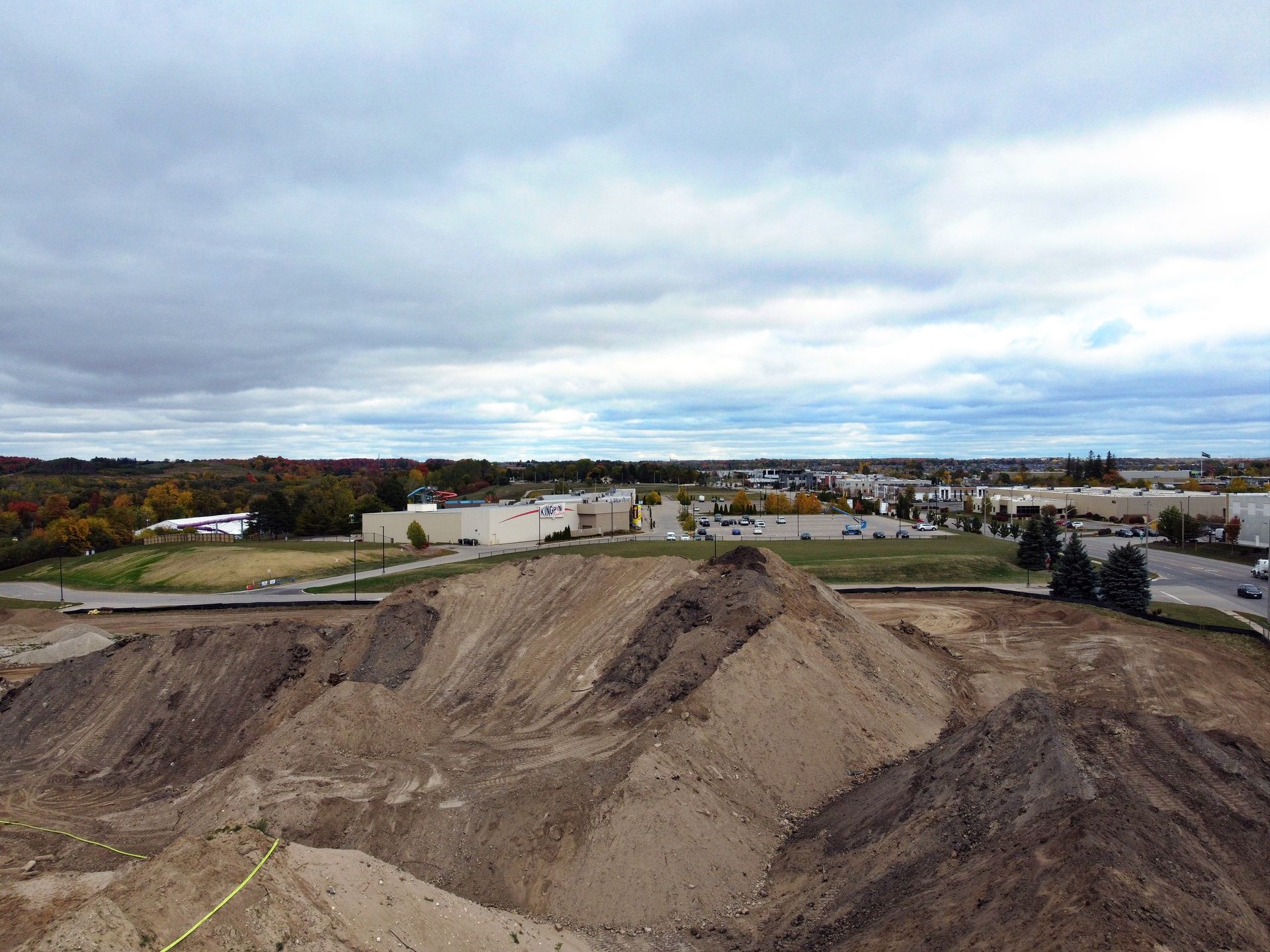 An aerial view of a large pile of dirt in a city.