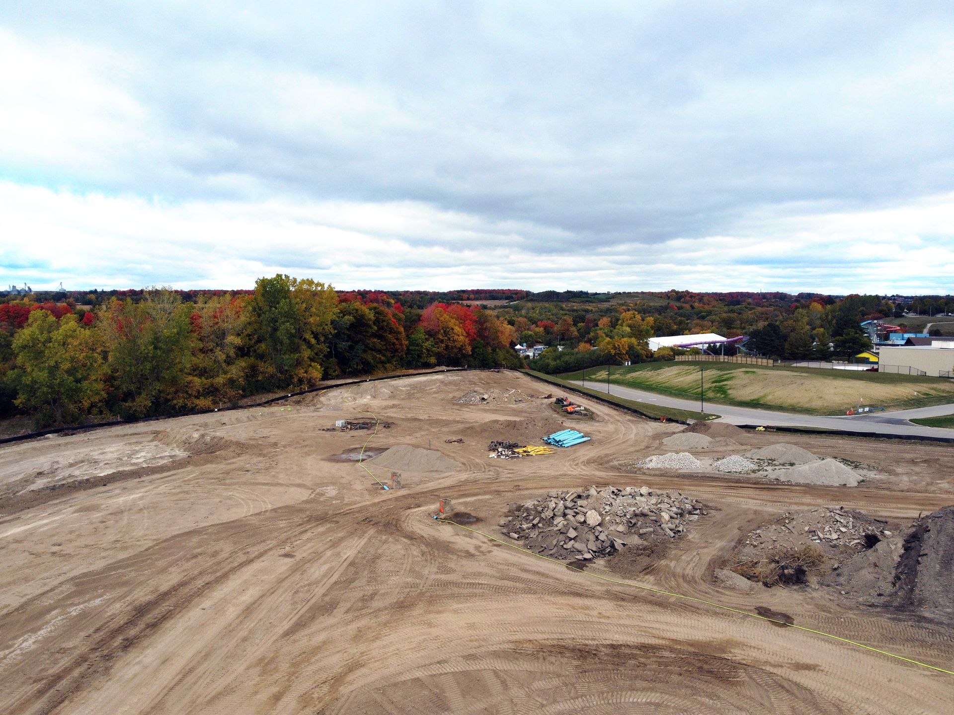 An aerial view of a construction site with trees in the background.