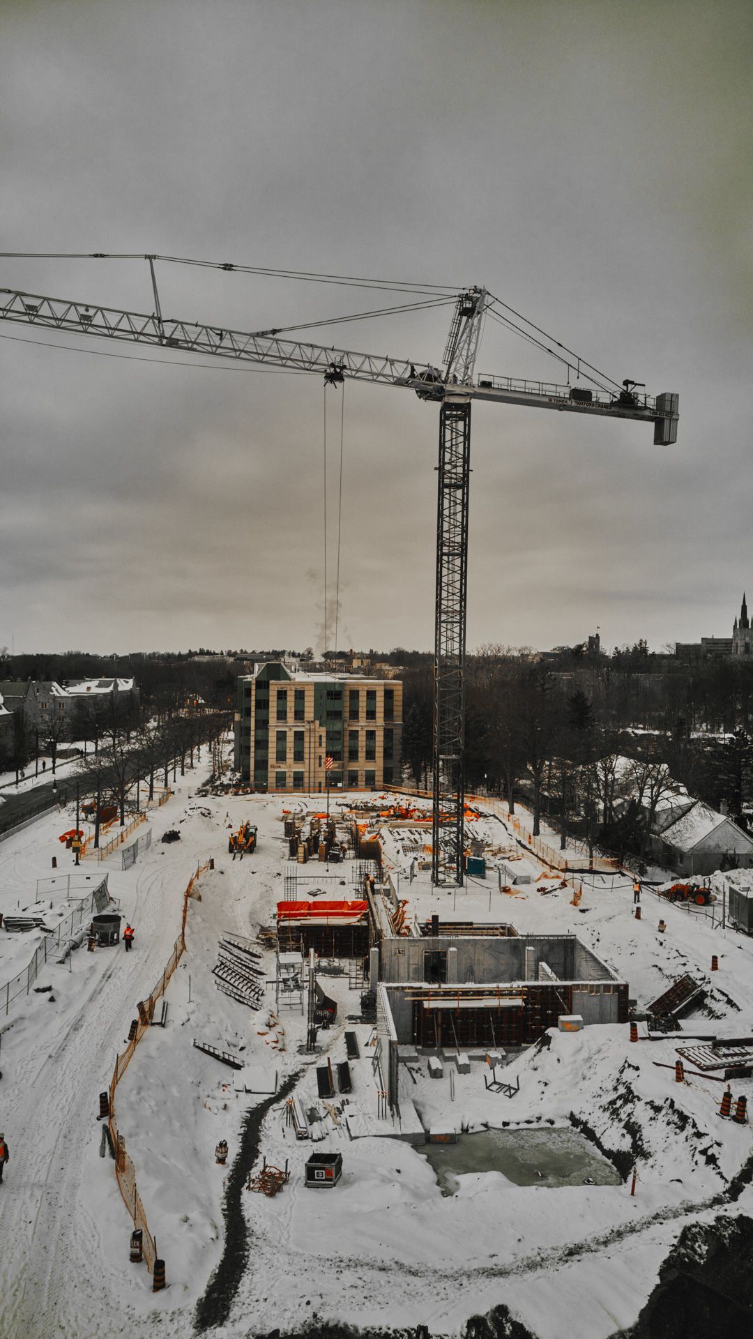 An aerial view of a construction site in the snow
