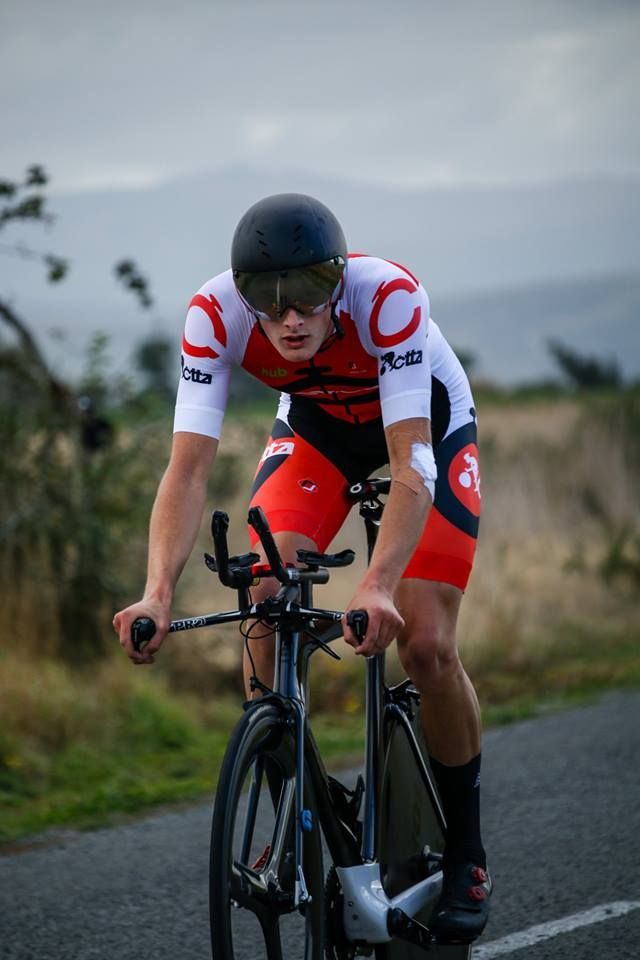 A man is riding a bike down a road.