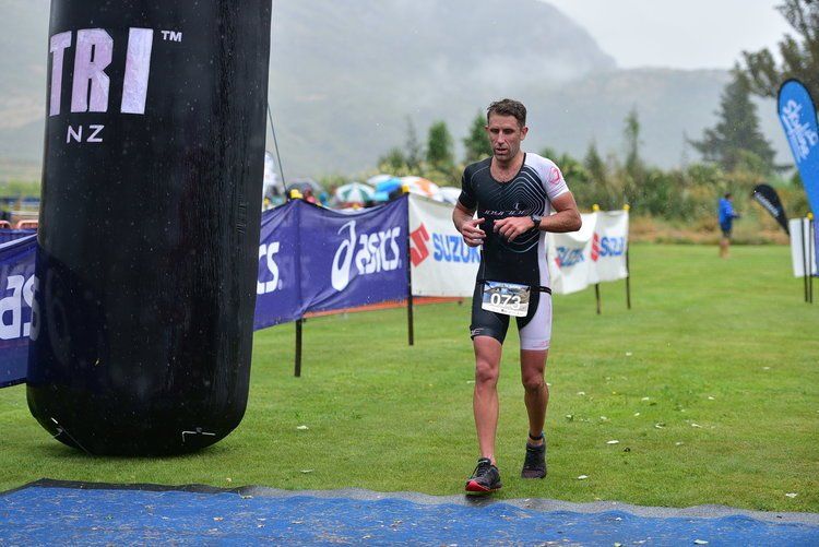 A man is running a marathon in a field.