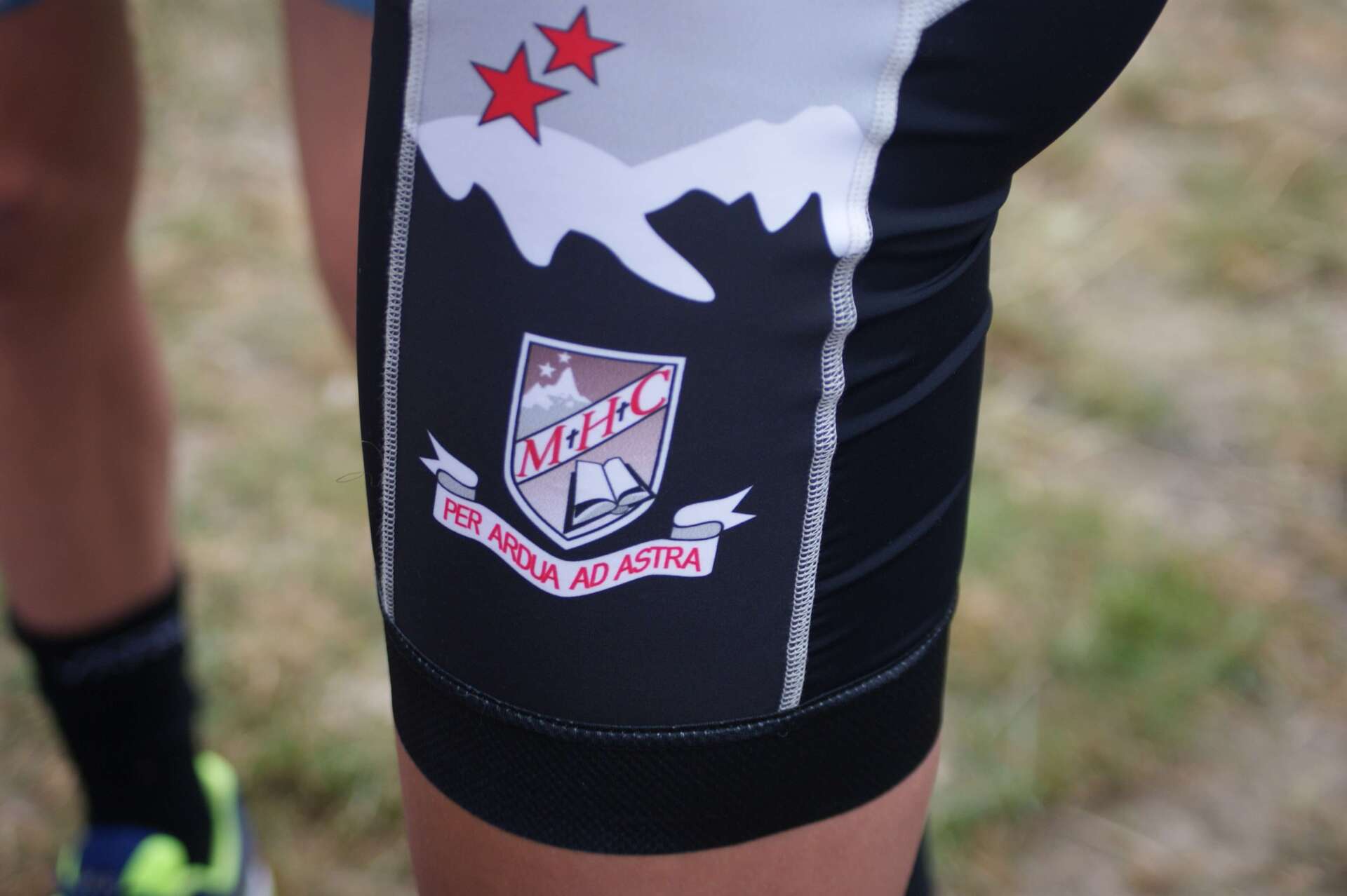 A person wearing a pair of shorts with a logo on the side