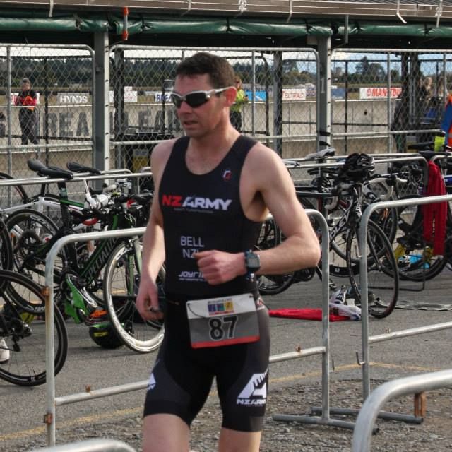 A man wearing a nz army shirt is running