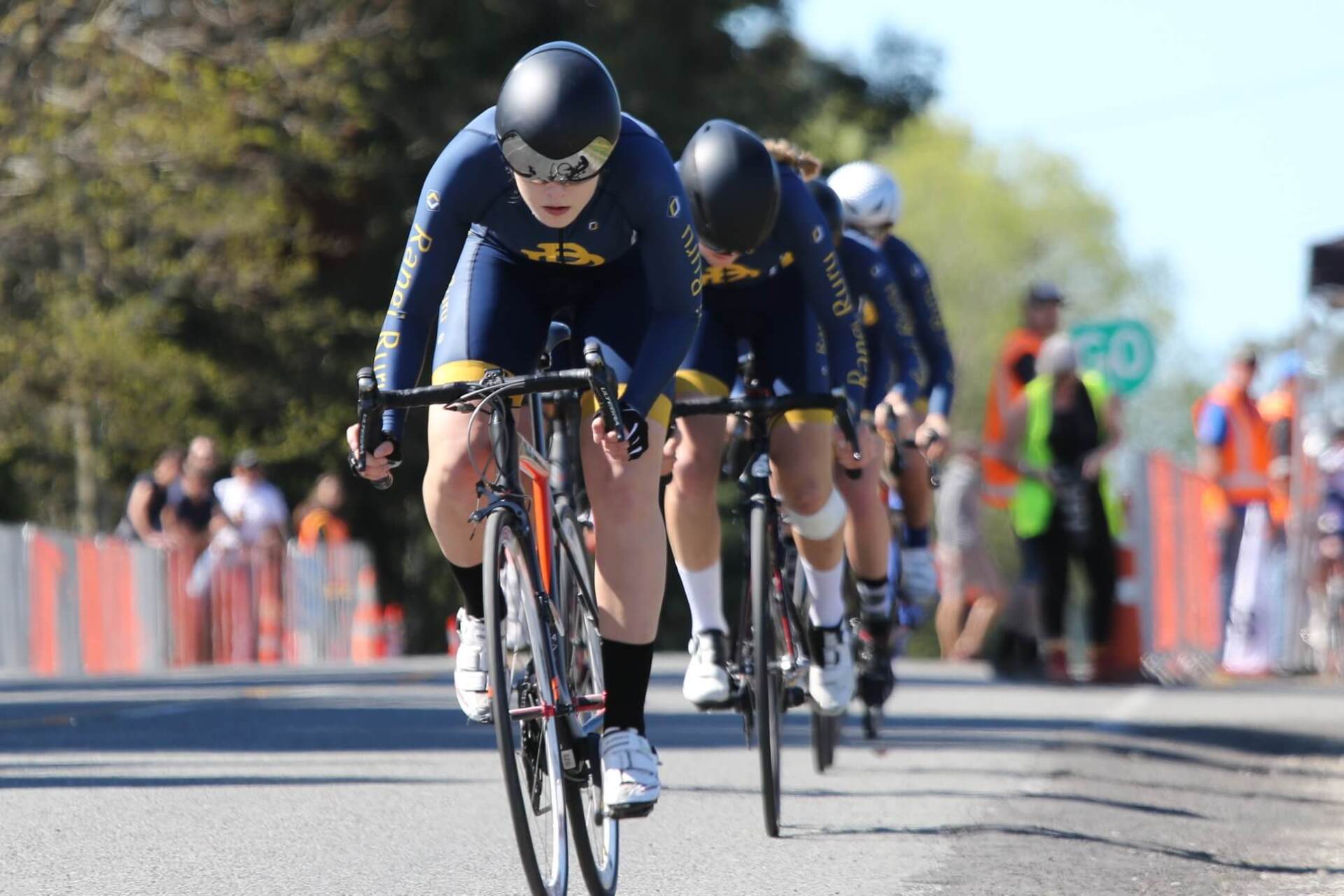 A group of people are riding bicycles down a road.