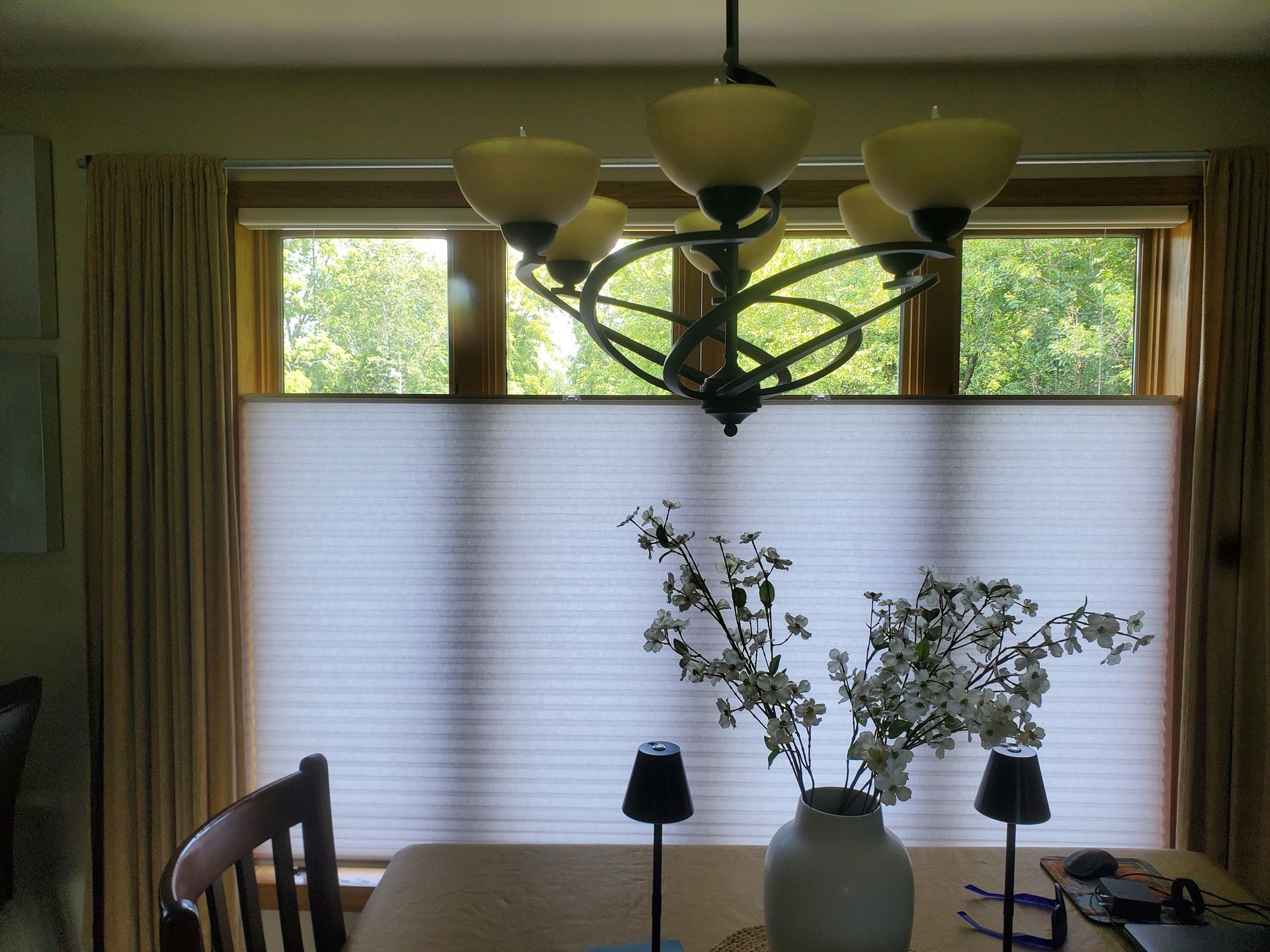 A dining room table with a vase of flowers on it | East Peoria, IL | Blinds For Less