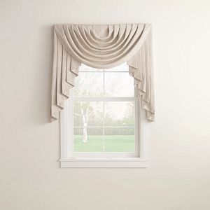 A window with a white curtain on it and a white wall.