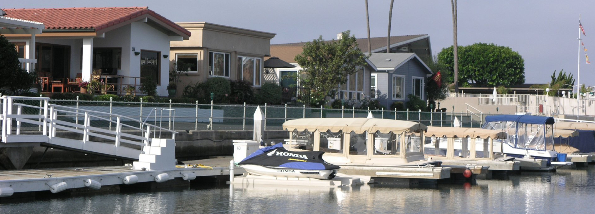 Electric Boats docked in the Marina in front of homes at Bayside Village.