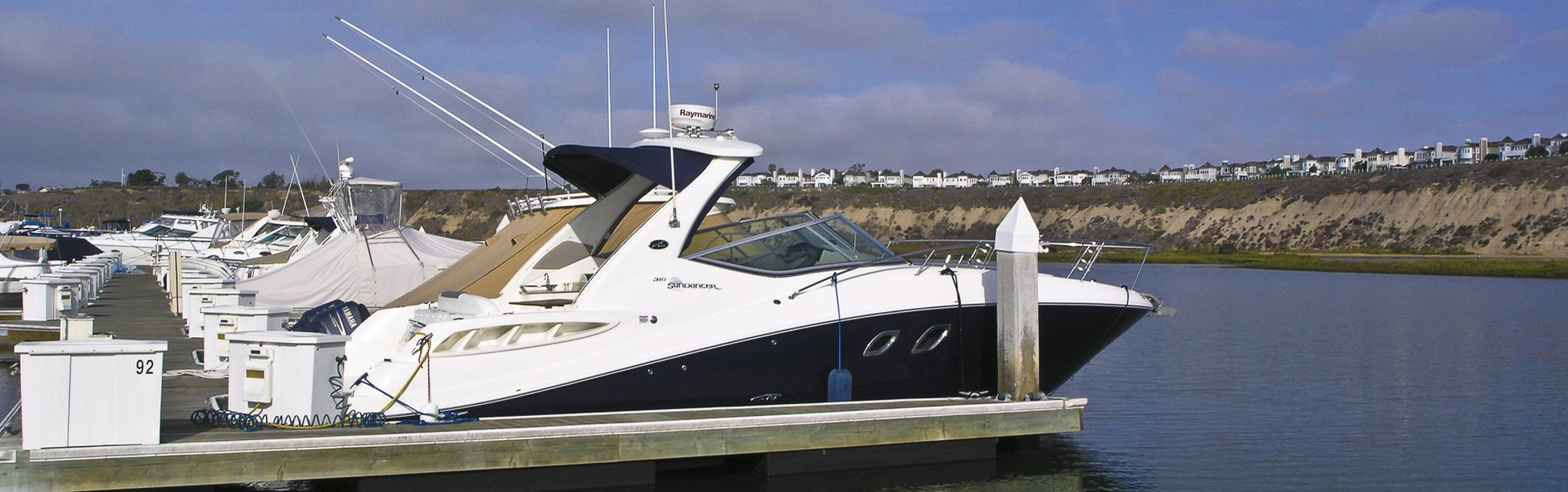 Boats in slips with bluffs in background