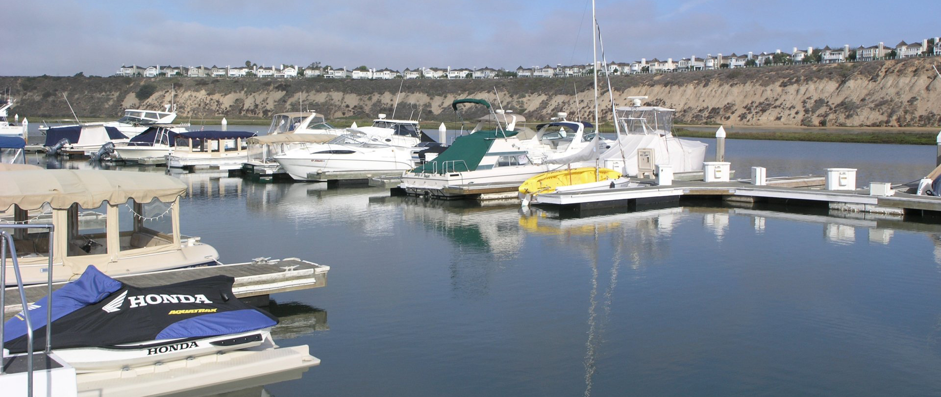 Boats in slips with channel bluffs in background