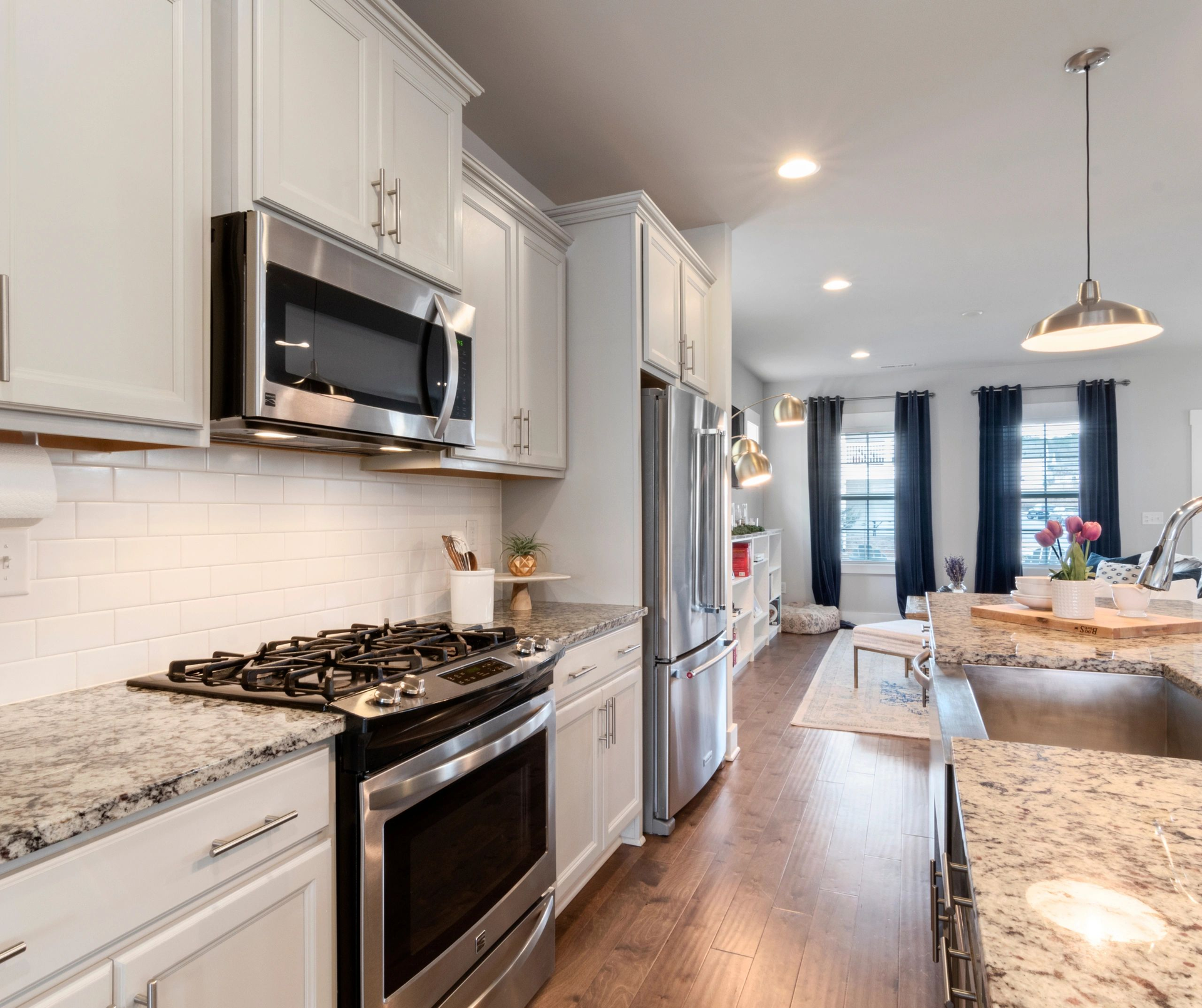 A kitchen with white cabinets and stainless steel appliances A kitchen with white cabinets and stainless steel appliances