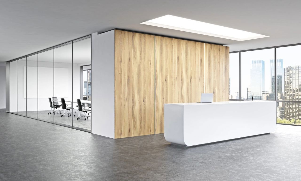 A modern office with a wooden wall and a white reception desk.