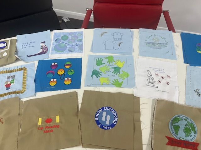 An array of squares on beige for the Covid Quilt Project