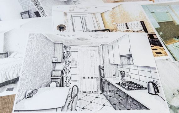 White house with dark blue ground floor, porch, and blue sky.