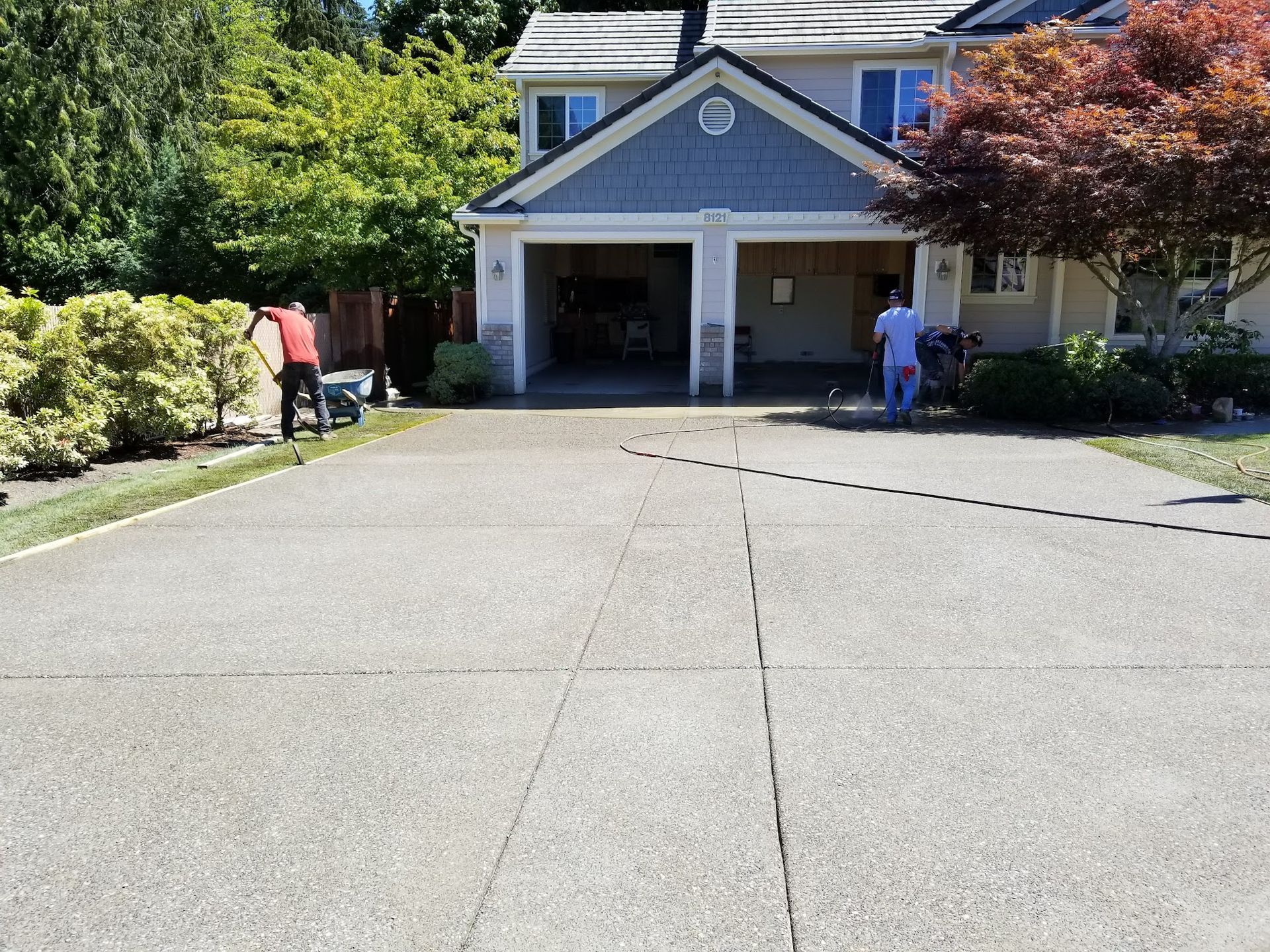 A couple of people are standing in front of a large house.