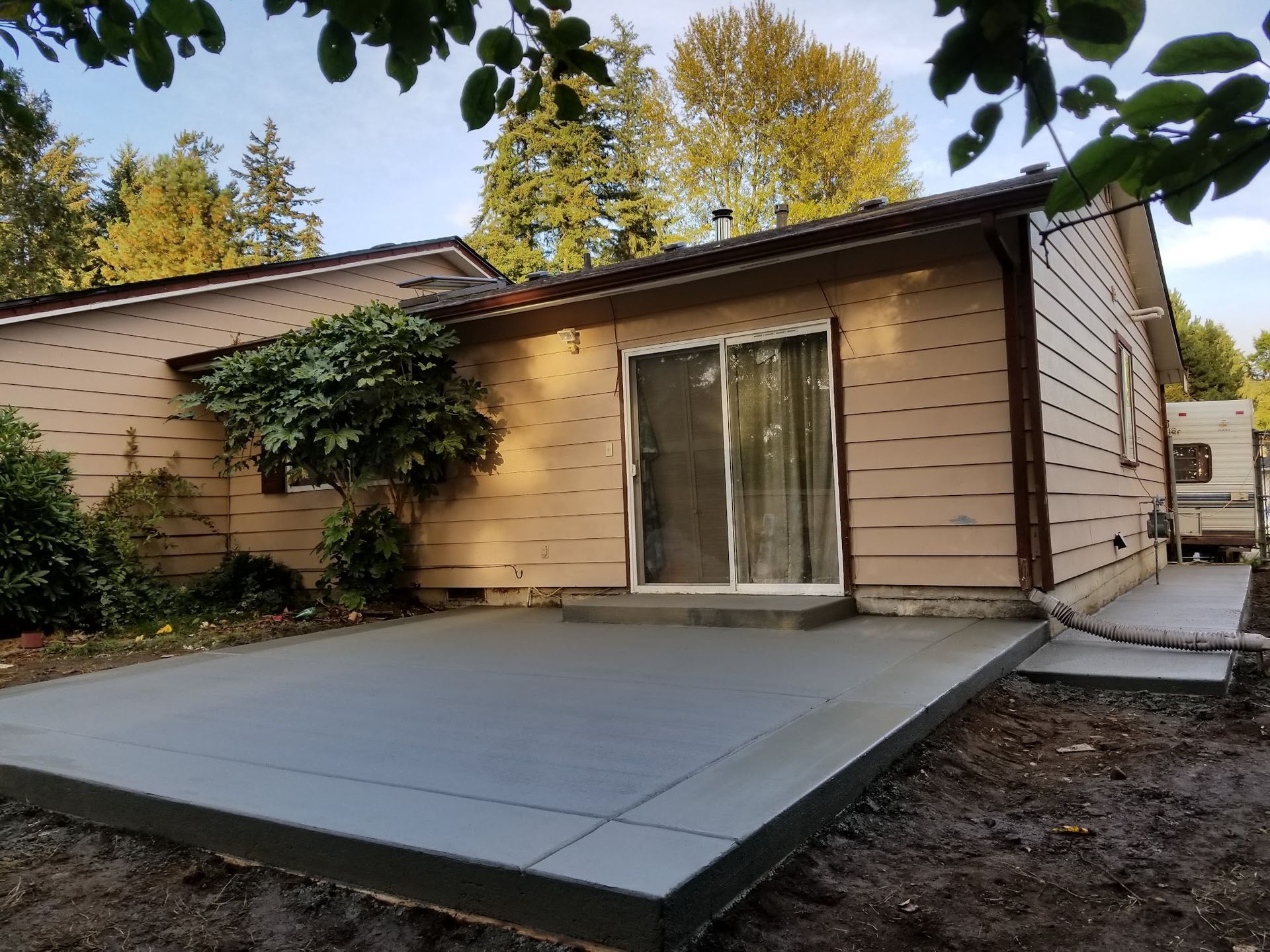 A house with a concrete patio in front of it