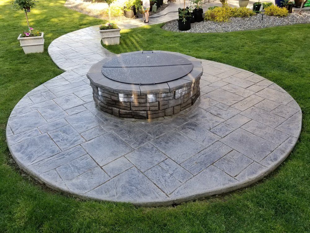 There is a fire pit in the middle of the patio.