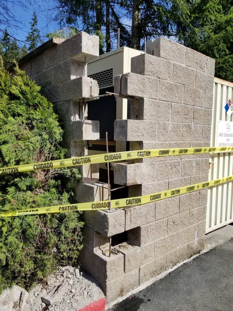 A brick wall with a yellow caution tape around it