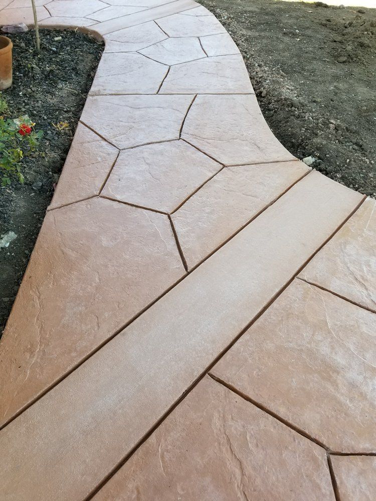 A concrete walkway with a geometric pattern on it