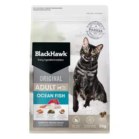 A bag of Black Hawk Original Adult Ocean Fish cat food with a black cat on the packaging, alongside the brand logo and product details.