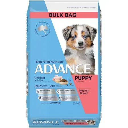 A bag of ADVANCE puppy food, featuring a blue and pink design with a photo of a puppy. It has a "bulk bag" label and details about the food's nutritional value.