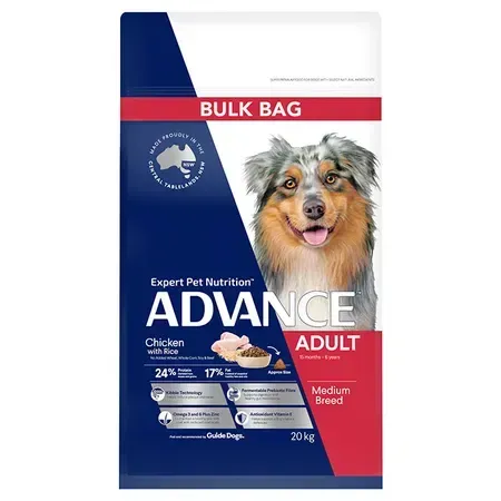 Bag of Advance Adult dog food, featuring a blue, white, and red design. A smiling Australian Shepherd is in the foreground.