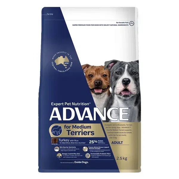 A bag of Advance dog food for medium terriers, featuring images of two happy dogs. The packaging is blue, white, and gold.